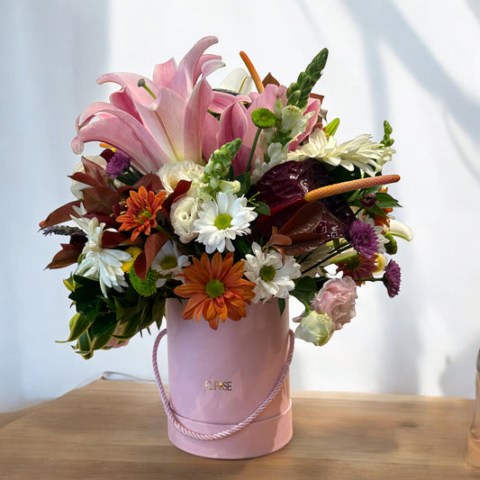 Arrangement of Lilies and Assorted Flowers in a Pink Box - Charm and Delicacy